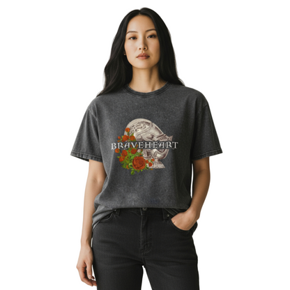 Woman wearing a dark gray t-shirt with 'Braveheart' design in a bright room.