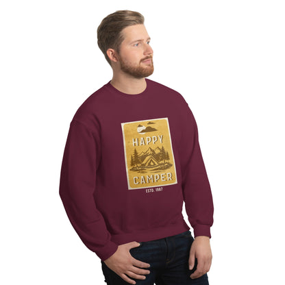 Man wearing a maroon sweatshirt with a 'Happy Camper' graphic against a white wall.