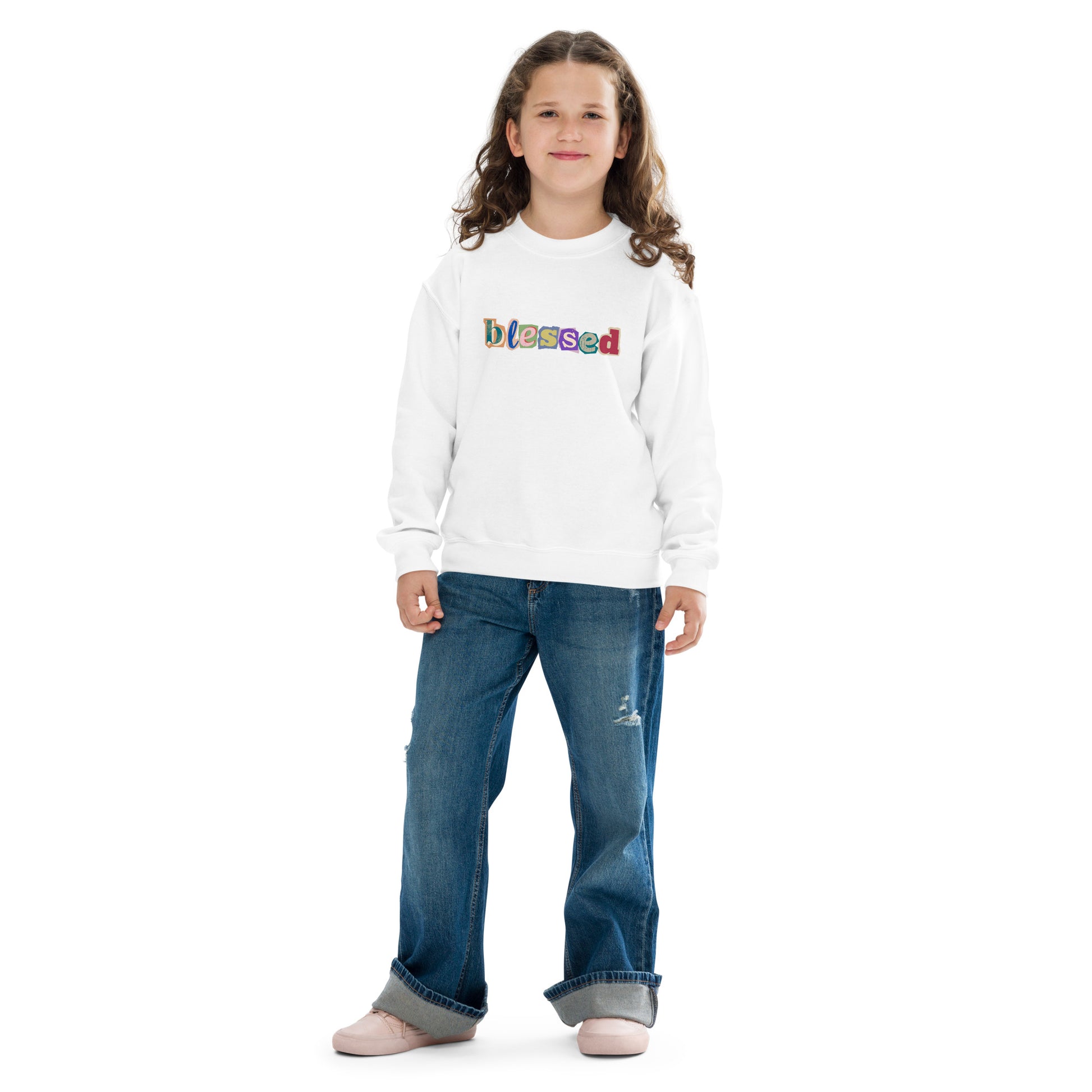 Child wearing a white sweatshirt with colorful text and blue jeans on a white background